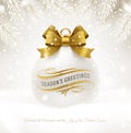 Christmas white bauble with glitter gold bow ribbon and greetings. Christmas ball on a snow. Royalty Free Stock Photo